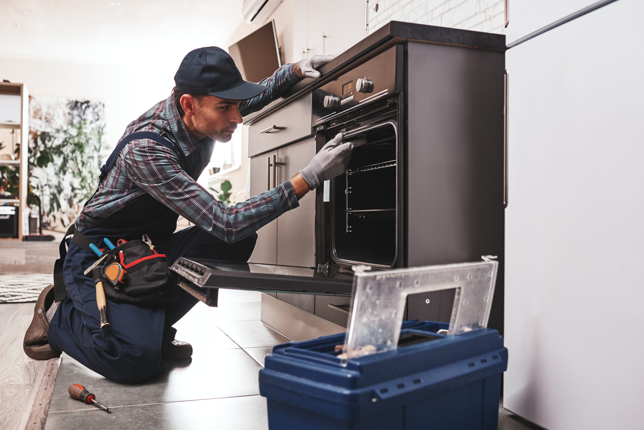 photo-54 don't delay with repair. close up of repairman examining oven