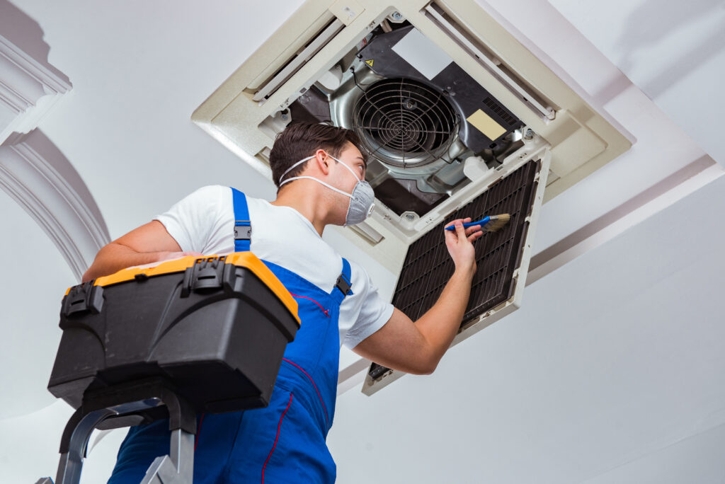 service-3 worker repairing ceiling air conditioning unit